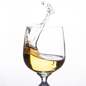 White wine splashing in wine glass